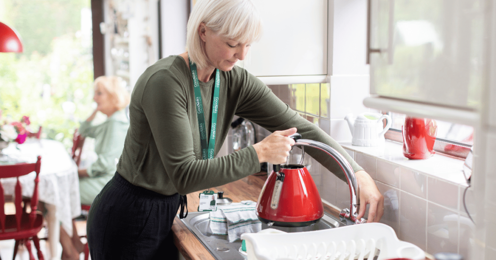 Signs of loneliness in elderly people: care professional making tea for an older person
