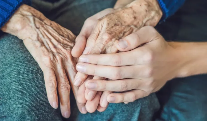 Professional GoodOaks home carer supporting an older adult with personalised care and companionship at home.