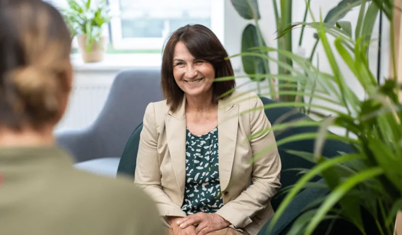 woman sitting and smiling. homecare business owner